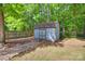A shed sits near a wood fence and mature trees adding charm to the backyard at 6688 Pine Forest Dr, York, SC 29745