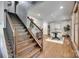 Elegant staircase leads to an open dining area, enhanced by hardwood floors and natural light at 6688 Pine Forest Dr, York, SC 29745