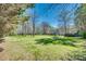 Expansive green yard surrounded by mature trees offers privacy and a sense of tranquility at 6688 Pine Forest Dr, York, SC 29745