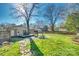 Expansive backyard with patio area, outdoor seating, mature trees, and well-maintained lawn at 6956 Oakstone Pl, Charlotte, NC 28210