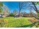 Wide backyard featuring a stone patio, outdoor dining, a wooden fence, and lush lawn at 6956 Oakstone Pl, Charlotte, NC 28210