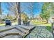 Inviting backyard with a wooden deck, outdoor dining set, BBQ, and a lush green lawn at 6956 Oakstone Pl, Charlotte, NC 28210