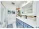 Bright bathroom features a blue vanity with modern fixtures, white countertop, and stylish decor details at 6956 Oakstone Pl, Charlotte, NC 28210