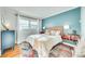 Charming bedroom with pops of color, natural light, hardwood floors, and cozy decor at 6956 Oakstone Pl, Charlotte, NC 28210
