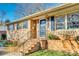 Inviting brick home exterior with blue door and well-maintained landscaping at 6956 Oakstone Pl, Charlotte, NC 28210