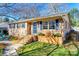 Charming brick home with blue door and shutters on a sunny day at 6956 Oakstone Pl, Charlotte, NC 28210