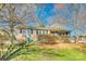 Charming brick home with blue shutters, well-maintained lawn, and mature landscaping at 6956 Oakstone Pl, Charlotte, NC 28210