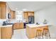Bright kitchen with white countertops, wooden cabinets, and a breakfast bar at 6956 Oakstone Pl, Charlotte, NC 28210