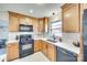 Updated kitchen featuring wooden cabinets, granite countertops, stainless steel appliances, and stylish backsplash at 6956 Oakstone Pl, Charlotte, NC 28210