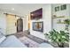 Cozy living room has a brick fireplace, exposed shelves, and a door to the laundry room at 6956 Oakstone Pl, Charlotte, NC 28210