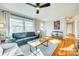 Comfortable living room with modern decor, large windows and hardwood floors at 6956 Oakstone Pl, Charlotte, NC 28210