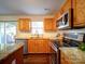 Modern kitchen featuring stainless steel appliances, granite countertops, and wood cabinets at 7120 Furlow Ln, Harrisburg, NC 28075