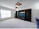 Cozy living room with carpet, ceiling fan, window and built in shelves at 7120 Furlow Ln, Harrisburg, NC 28075