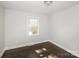 This bedroom offers neutral walls, dark wood-look floors, and a bright window at 7124 Brynhurst Dr, Charlotte, NC 28210