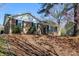 Inviting brick home with black shutters and budding trees at 7124 Brynhurst Dr, Charlotte, NC 28210