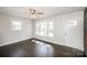 Well-lit living room boasts dark wood floors and neutral paint at 7124 Brynhurst Dr, Charlotte, NC 28210