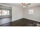 Open-concept living room with dark wood floors and connecting rooms at 7124 Brynhurst Dr, Charlotte, NC 28210
