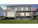 Rear view of home features a covered patio with an outdoor seating and dining area at 8310 Sandstone Crest Ln, Indian Land, SC 29707