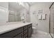 Elegant bathroom features a double sink vanity, glass shower and stylish decor at 8310 Sandstone Crest Ln, Indian Land, SC 29707