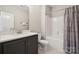 Bright bathroom featuring a shower over tub and vanity with stone countertop at 8310 Sandstone Crest Ln, Indian Land, SC 29707