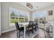 Bright dining area with large windows offering scenic views and an elegant table set for six at 8310 Sandstone Crest Ln, Indian Land, SC 29707