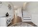 Welcoming foyer with staircase, decorative wall accents, hardwood floors, and natural light, for a bright entry at 8310 Sandstone Crest Ln, Indian Land, SC 29707
