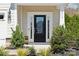 Elegant front door with sidelights, stylish hardware, and landscaping offering a warm welcome at 8310 Sandstone Crest Ln, Indian Land, SC 29707