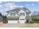 Two-story home with stone accents, two-car garage, well maintained landscape, and inviting curb appeal at 8310 Sandstone Crest Ln, Indian Land, SC 29707