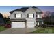 Charming two-story home features a well-manicured lawn, garage, and traditional architectural details at 8310 Sandstone Crest Ln, Indian Land, SC 29707