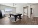 Entertain in this billiards room with light wood floors and bright window at 8310 Sandstone Crest Ln, Indian Land, SC 29707
