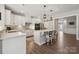 Bright kitchen features white cabinetry, stainless steel appliances, a center island with counter seating at 8310 Sandstone Crest Ln, Indian Land, SC 29707