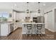 Beautiful kitchen with stainless steel appliances, white cabinets, a central island, and modern lighting fixtures at 8310 Sandstone Crest Ln, Indian Land, SC 29707