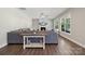Cozy living room featuring a fireplace, TV, gray sectional sofa, and large windows providing ample natural light at 8310 Sandstone Crest Ln, Indian Land, SC 29707