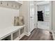 Mud room with convenient bench, cubbies, coat hooks, and hardwood flooring at 8310 Sandstone Crest Ln, Indian Land, SC 29707