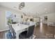 Open-concept kitchen, dining, and living area with hardwood floors, natural light, and stylish design at 8310 Sandstone Crest Ln, Indian Land, SC 29707