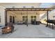 Spacious covered patio with a firepit, grill and outdoor seating at 8310 Sandstone Crest Ln, Indian Land, SC 29707