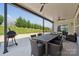 This covered patio includes a barbeque grill, outdoor dining area, and lovely view at 8310 Sandstone Crest Ln, Indian Land, SC 29707