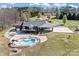Aerial shot of the back of the property with a pool, wooden deck, and a long concrete parking pad at 1030 Hurley School Rd, Salisbury, NC 28147