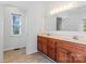 Bathroom with double sink vanity, ceramic floors and natural light from the window at 1030 Hurley School Rd, Salisbury, NC 28147