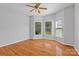 Bedroom features hardwood floors, neutral colored walls, a ceiling fan, and multiple large windows at 1030 Hurley School Rd, Salisbury, NC 28147
