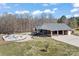 Wide shot of the back exterior of the home featuring a large pool, backyard, carport, and deck at 1030 Hurley School Rd, Salisbury, NC 28147