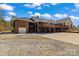 Exterior shot of a brick two-story home featuring a large deck and a multi-car garage at 1030 Hurley School Rd, Salisbury, NC 28147
