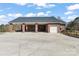 Beautiful red brick home featuring a large carport, an attached garage, and large concrete parking pad at 1030 Hurley School Rd, Salisbury, NC 28147