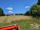 Expansive lawn with a charming house featuring a covered porch and ample outdoor space, ideal for relaxation and recreation at 1030 Hurley School Rd, Salisbury, NC 28147