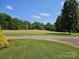Lush green lawn stretches from the driveway to the tree line, complementing the home's curb appeal at 1030 Hurley School Rd, Salisbury, NC 28147