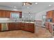 Kitchen with a central island, wooden cabinets, tile flooring, and a view of the dining area at 1030 Hurley School Rd, Salisbury, NC 28147
