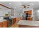 Open-concept kitchen with stainless steel appliances, breakfast bar, and view to the living space at 1030 Hurley School Rd, Salisbury, NC 28147