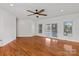 Bright living room boasts hardwood floors, neutral walls, ceiling fan, and sliding doors to outdoor patio at 1030 Hurley School Rd, Salisbury, NC 28147