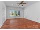 Bright living room boasts hardwood floors, neutral walls, and a picture window to let in natural light at 1030 Hurley School Rd, Salisbury, NC 28147
