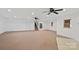 Large living room with carpet, recessed lighting, ceiling fans, and access to stairs at 1030 Hurley School Rd, Salisbury, NC 28147